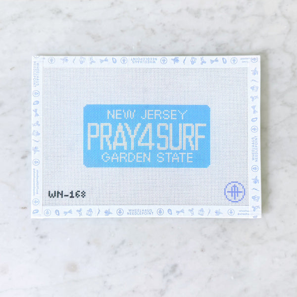 New Jersey license plate with 'PRAY4SURF' text on a marble background