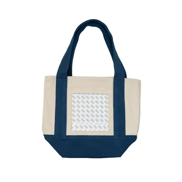 Tote bag with navy handles and beige front panel on a white background